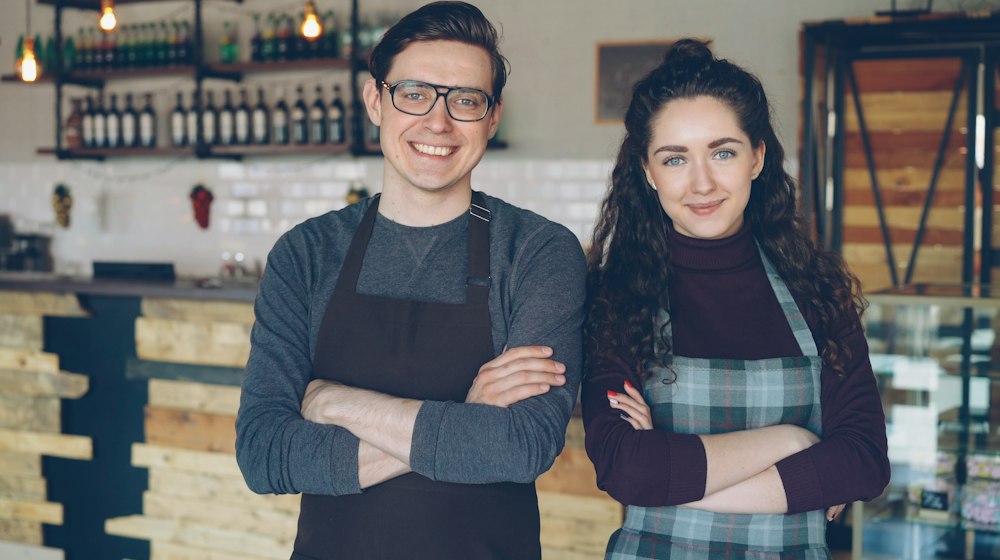 Two small-business owners standing together